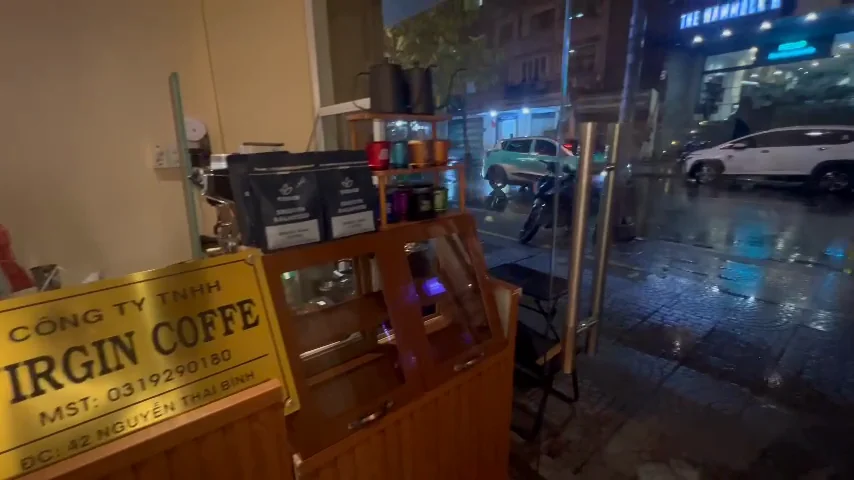 The counter in the evening, with Nguyễn Thái Bình wet through the glass behind it.
