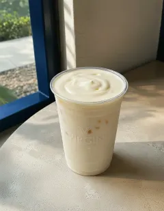 Cheese yogurt in the Virgin cup, thick white yogurt under a pale ivory cheese-cream swirl on top.
