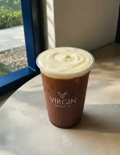 Iced chocolate with cheese cream in the Virgin cup, uniform brown chocolate under a thick plain ivory cheese-cream cap.