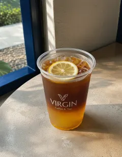 Cold brew coffee with honey and lemon in the Virgin cup, a golden honey layer beneath clear dark coffee, garnished with a lemon slice.