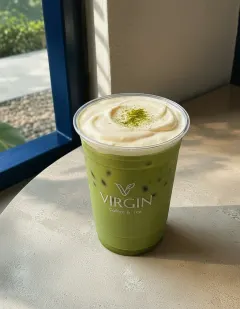 Iced matcha with salted cream in the Virgin cup, uniform green matcha under a thick ivory salted-cream cap dusted with matcha.