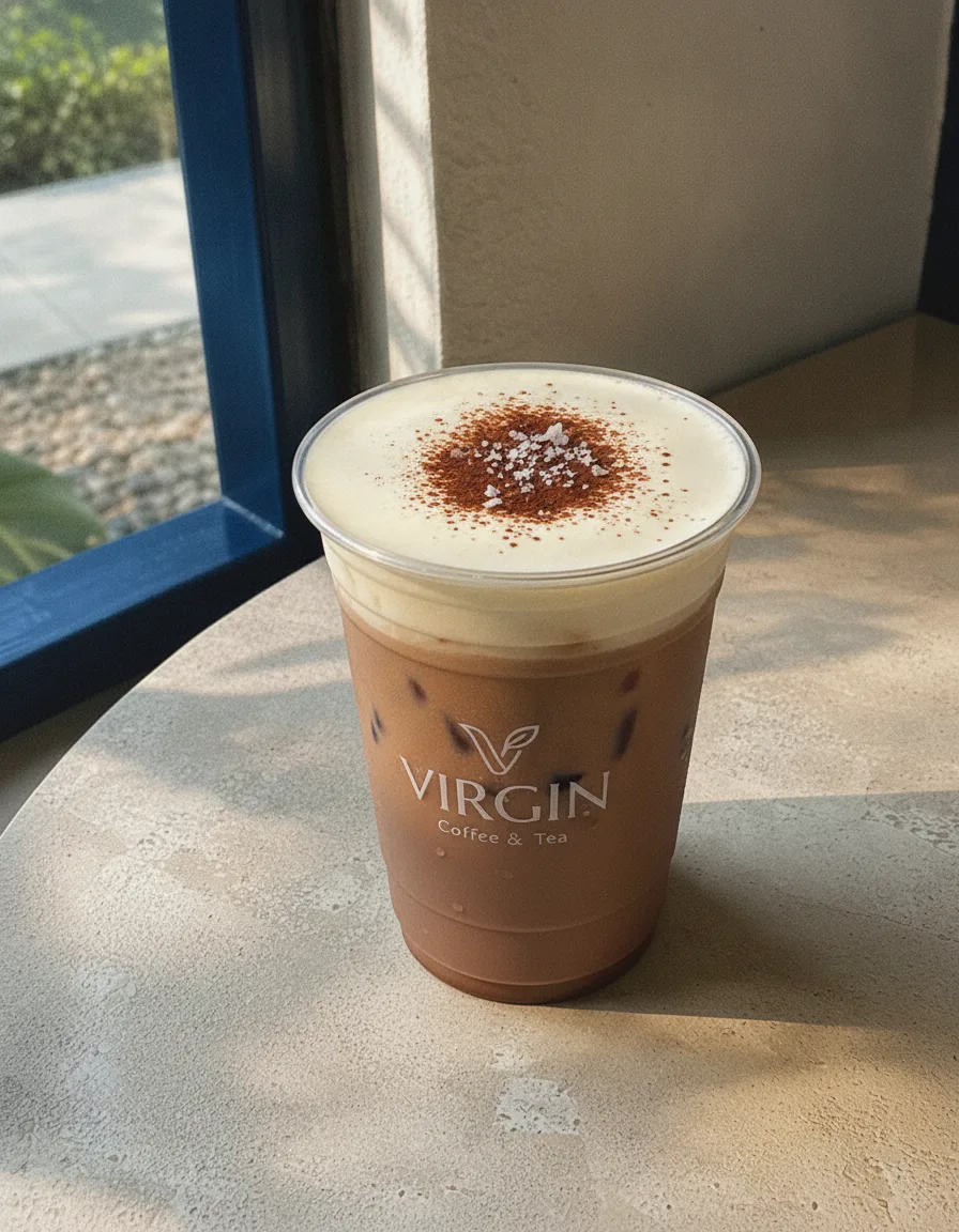 Iced chocolate with salted cream in the Virgin cup, cacao base under a thick ivory salted-cream cap dusted with cocoa and flaky salt.
